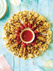 Chicken skewers arranged in a circle around dipping sauce