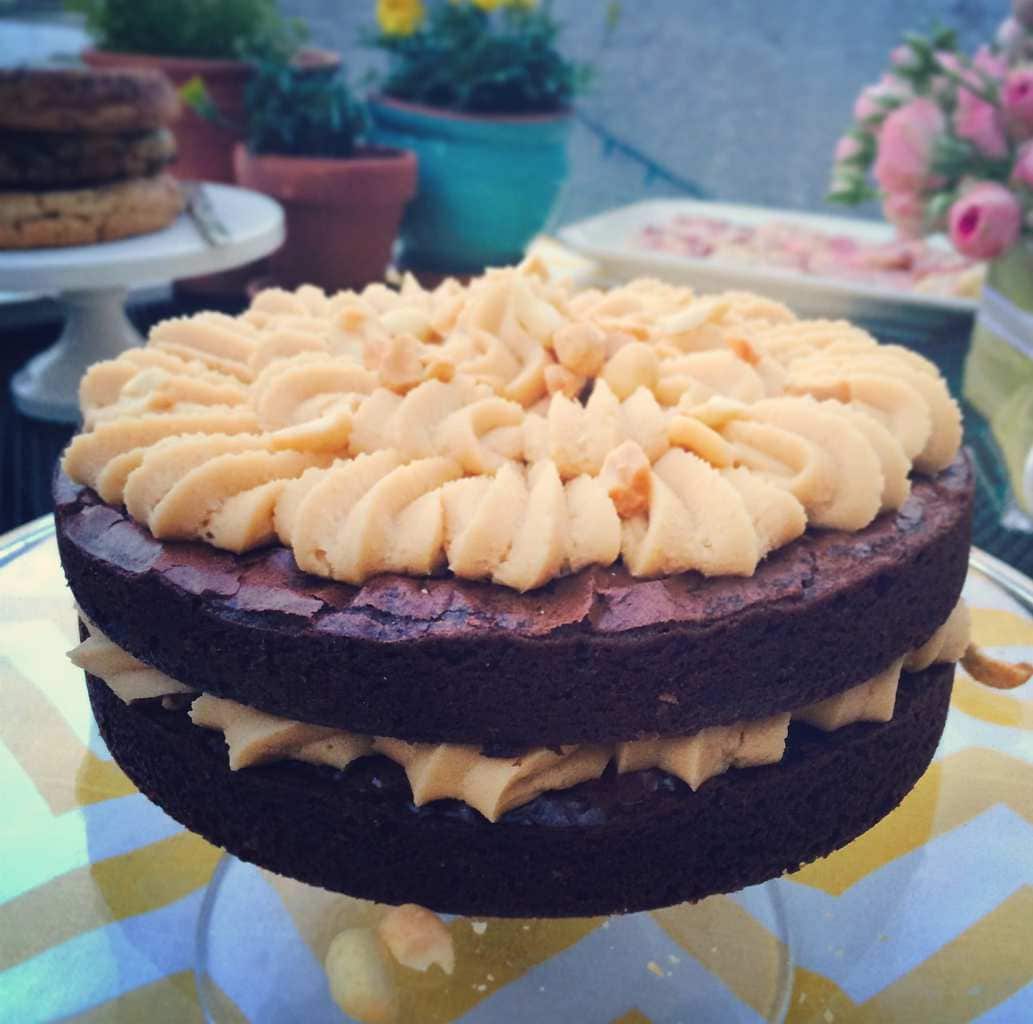 Peanut Butter Brownie Cake sitting on a table at a party