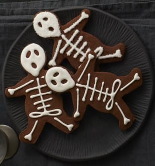 black plate with chocolate skeleton cookies