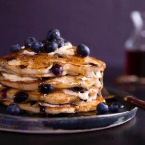 blueberry pancakes on a blue plate