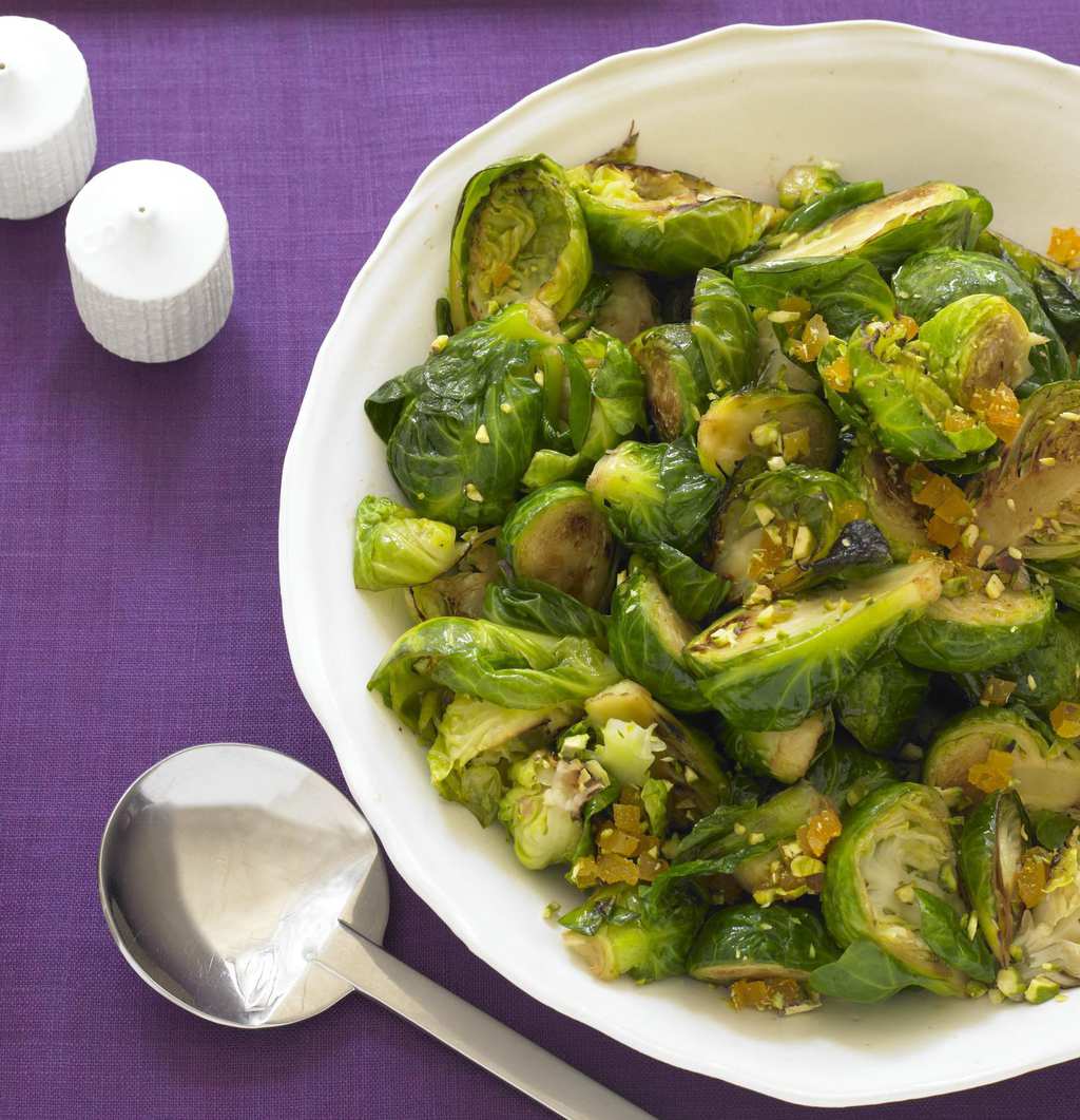 Brussels Sprouts in white bowl with orchid background