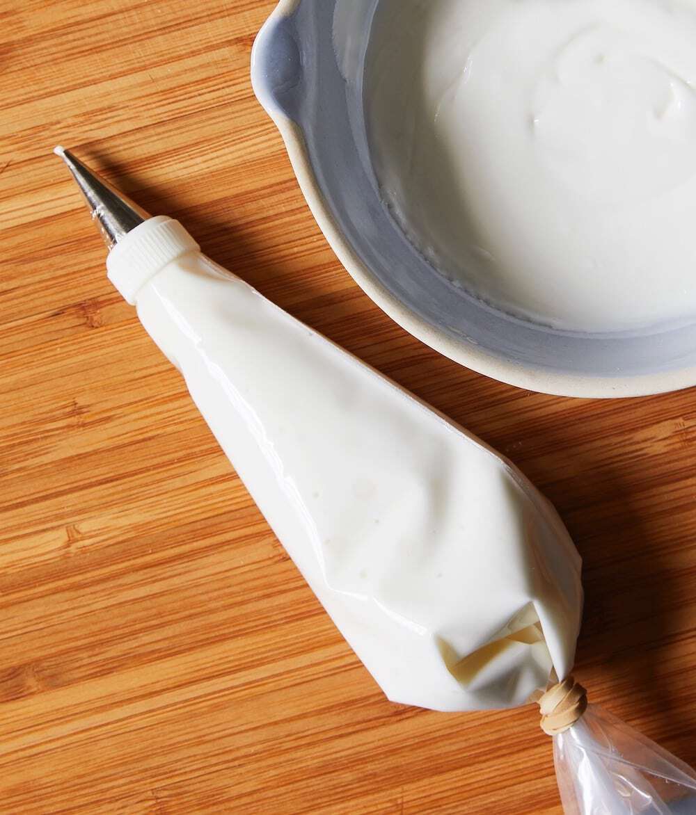 Piping bag on a cutting board with royal icing