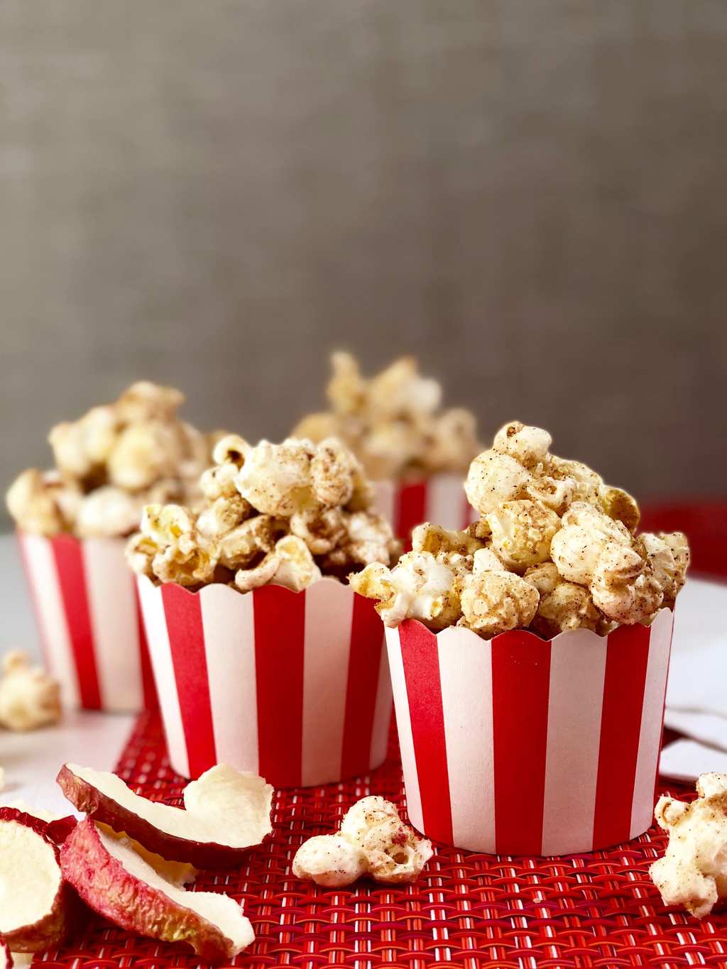 Apple cinnamon popcorn in red and white cups