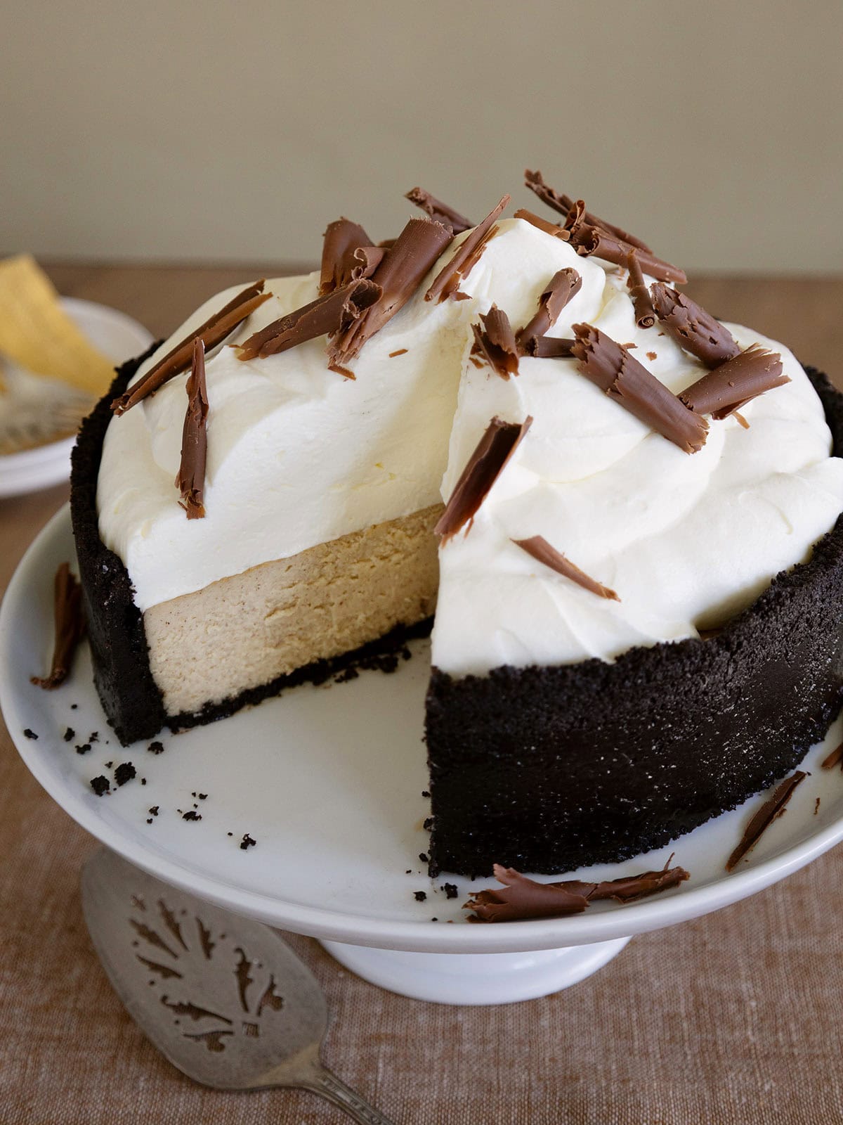 A ginger cheesecake with a slice removed to see layers.