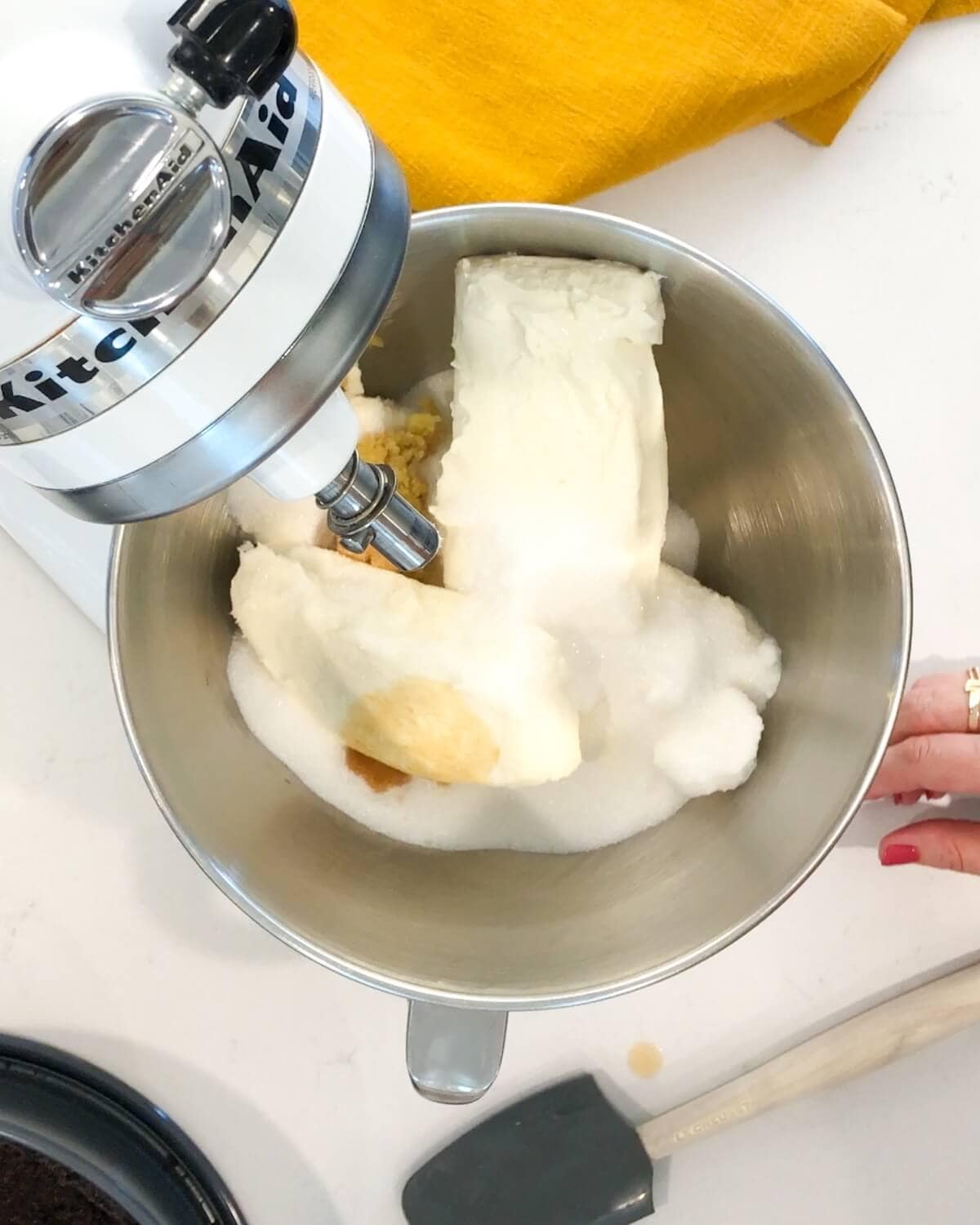 Cream cheese, sugar, vanilla, and grated ginger in the bowl of a stand mixer.