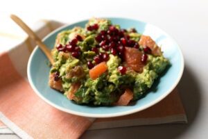 Grapefruit Guacamole with pomegranates in blue bowl
