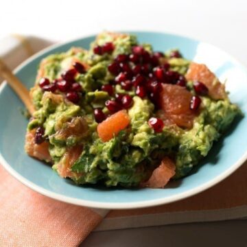 Grapefruit Guacamole with pomegranates in blue bowl