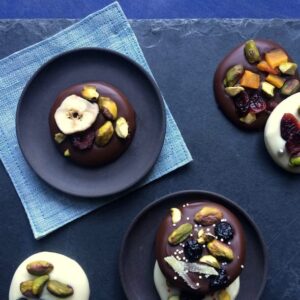 Chocolate bark cookies topped with nuts and fruit