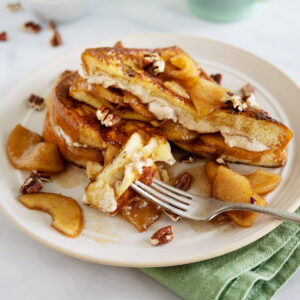 close up of Apple French toast with cream cheese filling and a bite taken out.