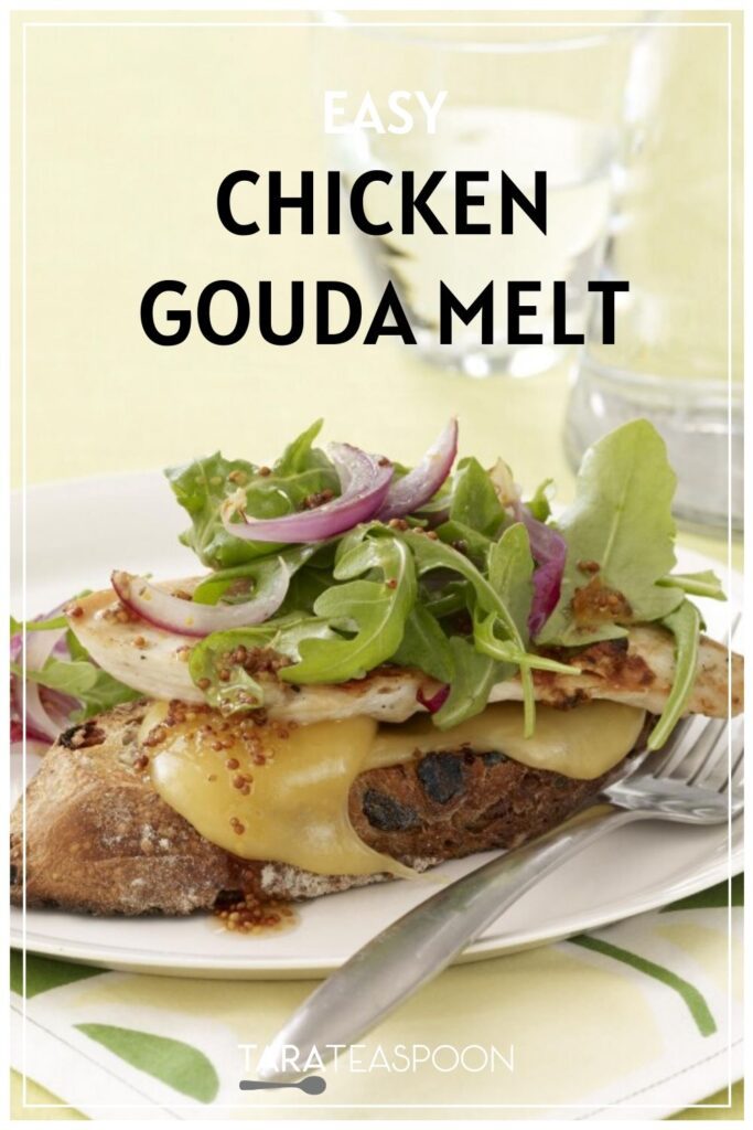 Chicken and gouda melt sandwich with an arugula and red onion garnish