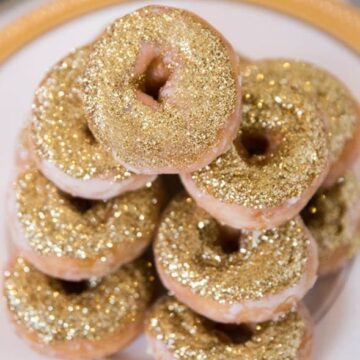 Pile of Glittering Gold Donuts on plate