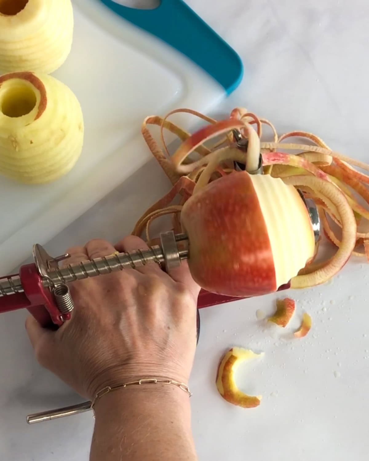 Using an apple corer to peel and core apples.