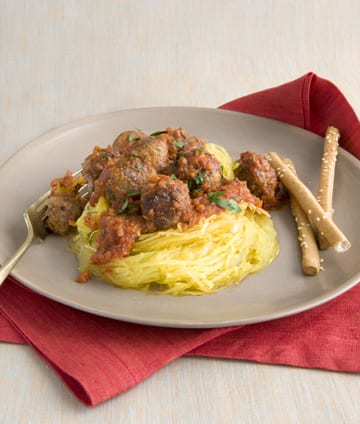 Meatballs and squash on gray plate red napkin
