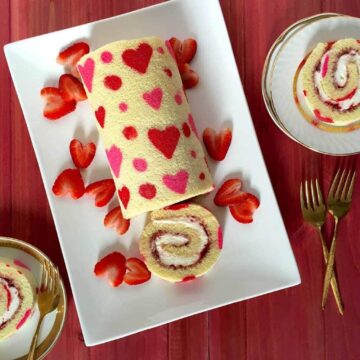 Valentine's Day Strawberry Cake Roll on white platter