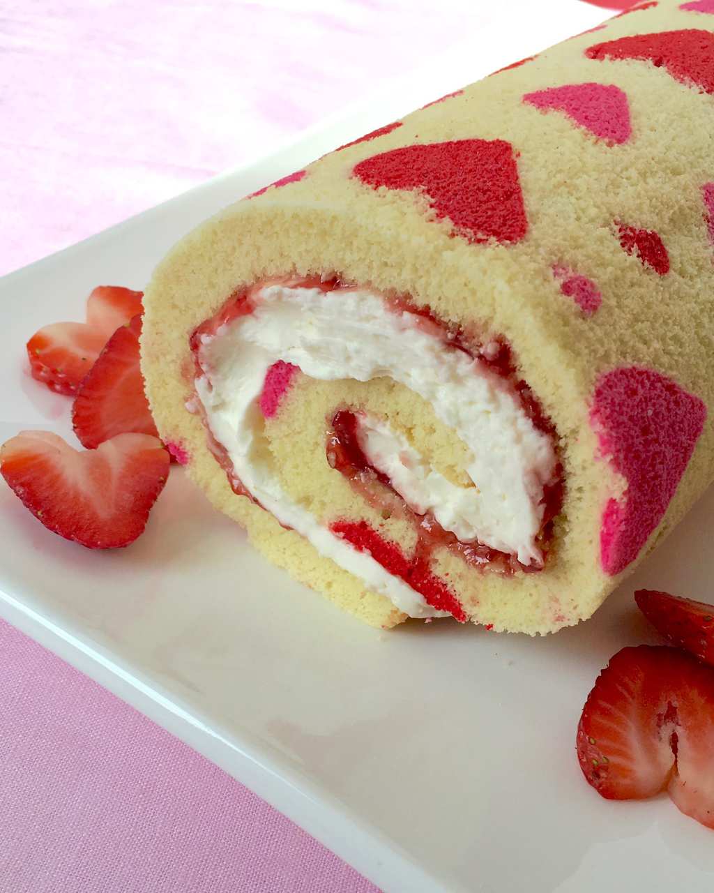 A strawberry roll cake decorated for Valentine's Day