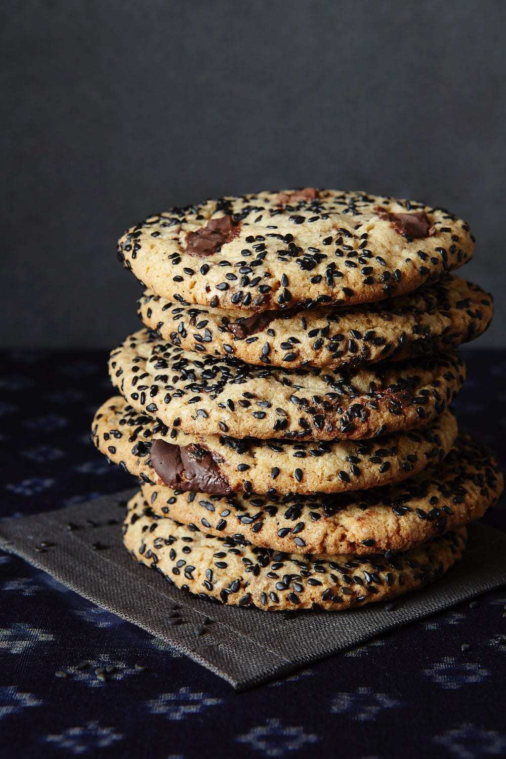 Black Sesame Cookies Stacked on black linen napkin