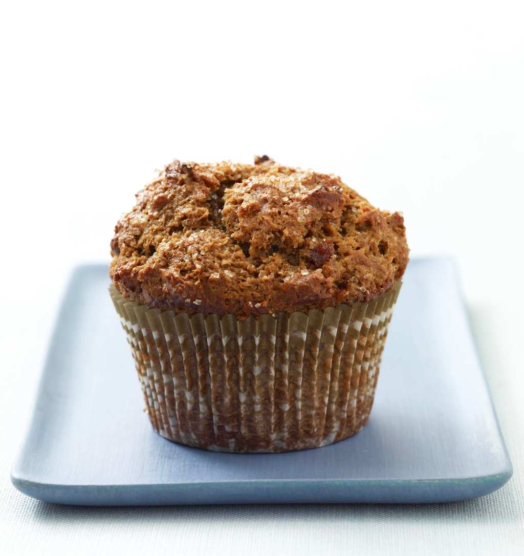 A bran muffin on a white plate. 