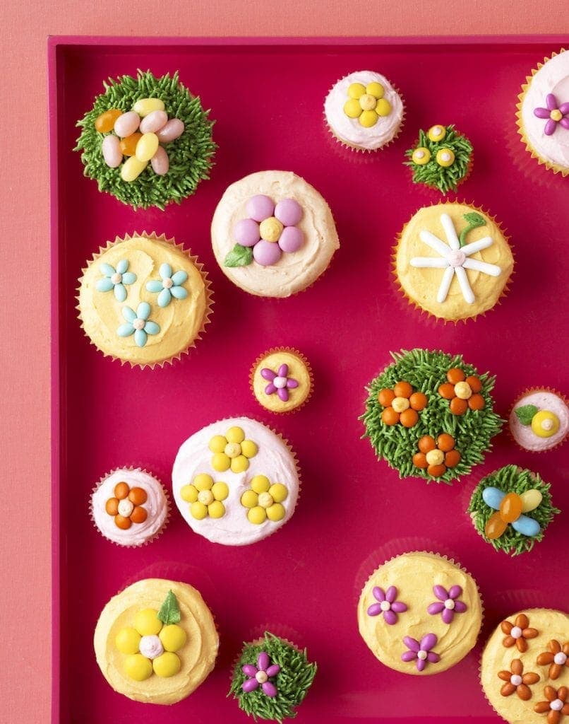 Overhead view of decorated cupcakes with floral and spring designs