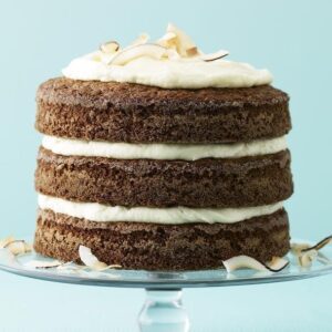 Ginger Coconut Carrot Cake on glass cake pedestal