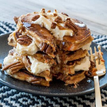 Carrot cake pancakes with cream cheese frosting and pecans