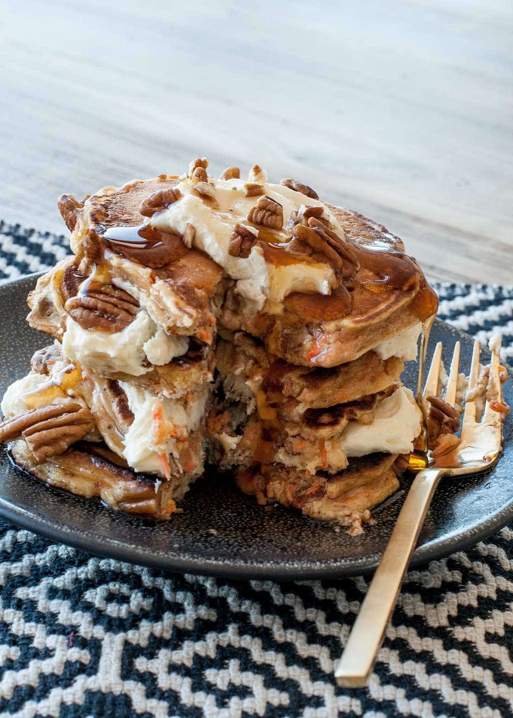 Carrot cake pancakes with frosting on gray plate