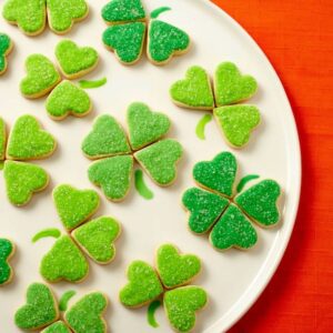 Bite sized Irish Heart Shamrock Cookies in white plate