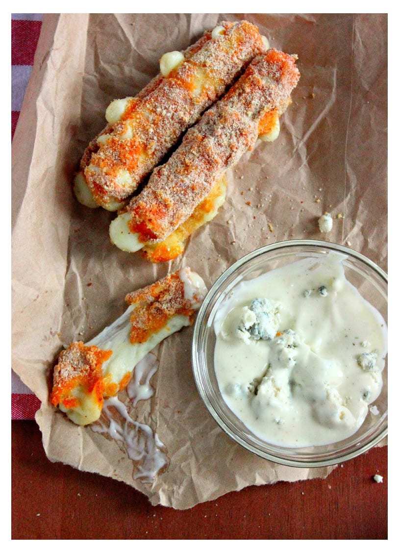 Mozzarella sticks with dip on brown paper bag