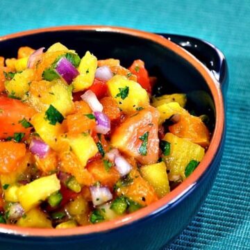 island fruit salsa in a bowl with pineapple and red onions