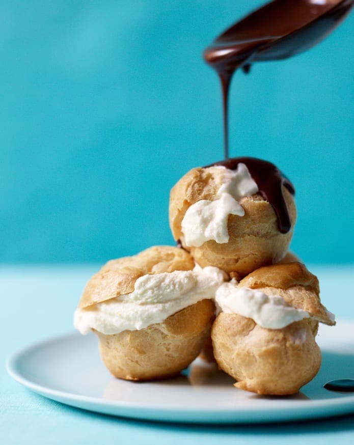 Choux pastry cream puffs with hot fudge sauce and ice cream