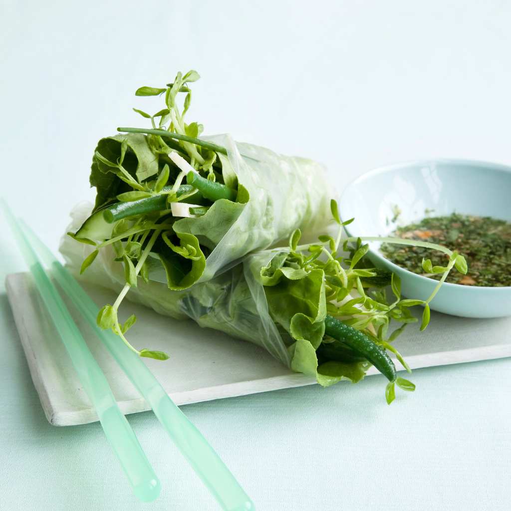 Veggie Spring Rolls on white plate, chopsticks and sauce.