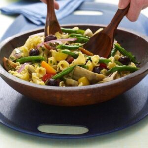 herbed vegetable pasta with artichokes mixed in salad bowl