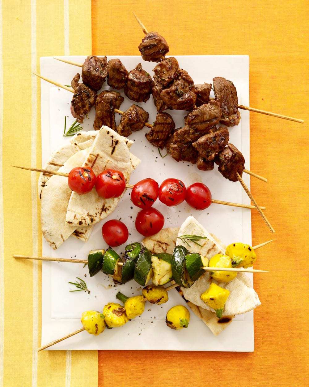 Lemon Herb Lamb And Vegetable Kabobs on white platter