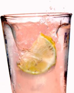 Pink lemonade in a glass with lemon slice