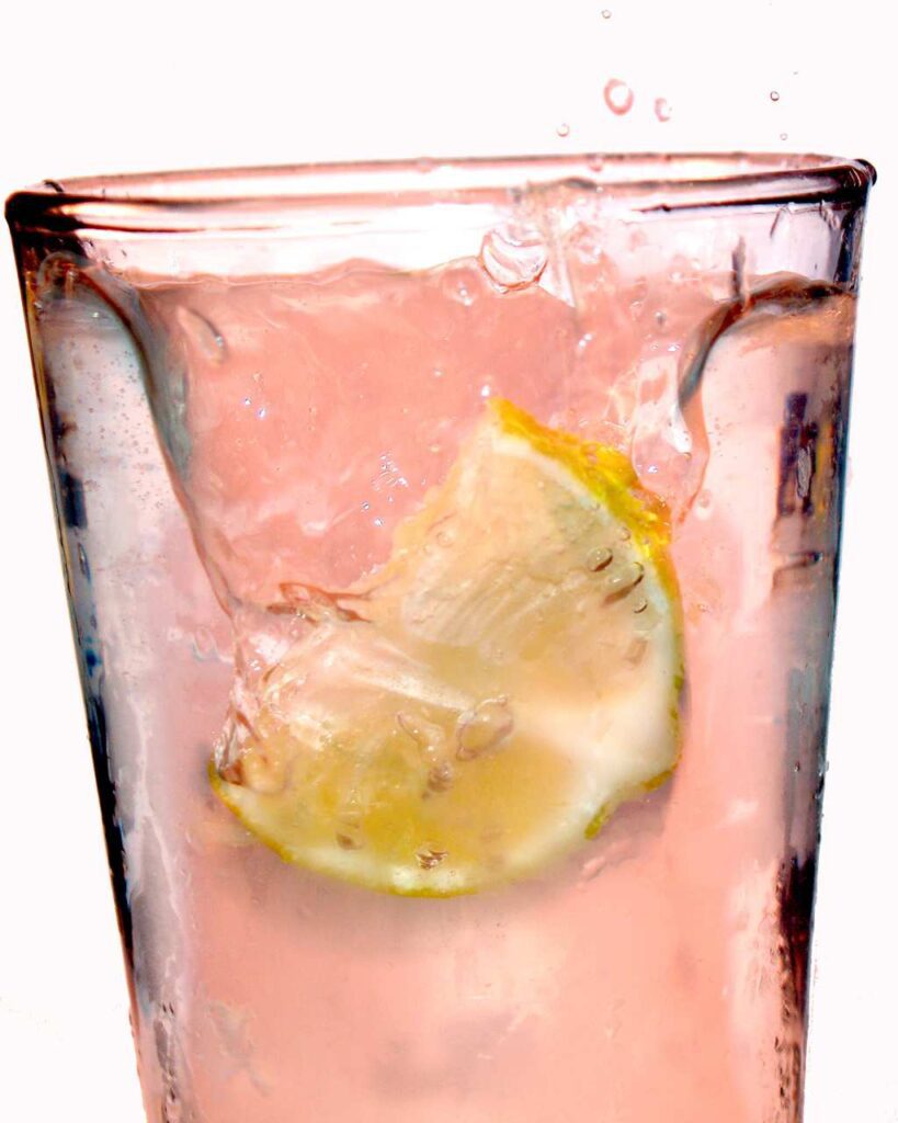 Pink lemonade in a glass with lemon slice