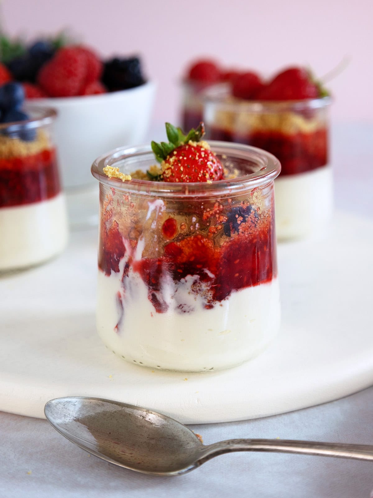 A mini cheesecake jar with a few bites removed.