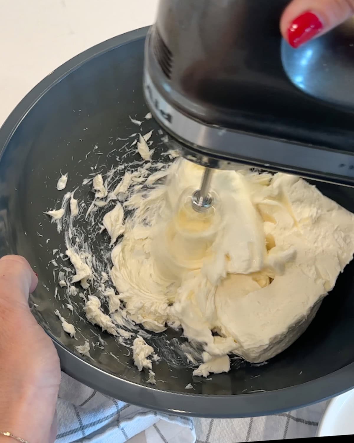 Mixing cream cheese to be light and fluffy.