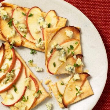 Apple and blue cheese tarts on cream colored surface