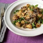 A plate of Easy Parmesan Mushroom Gnocchi with mushrooms and onions