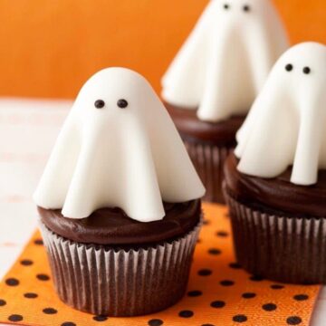 Floating ghost cupcakes on orange and black polka dot napkin