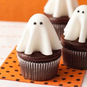 Close up of Floating ghost cupcakes on orange and black polka dot napkin