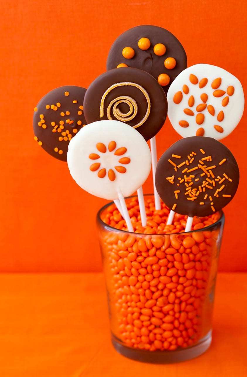 Easy Halloween Chocolate Lollipops in glass on orange background