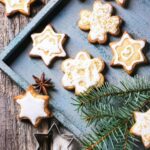 Cutout sugar cookies frosted with Royal Icing in wood platter