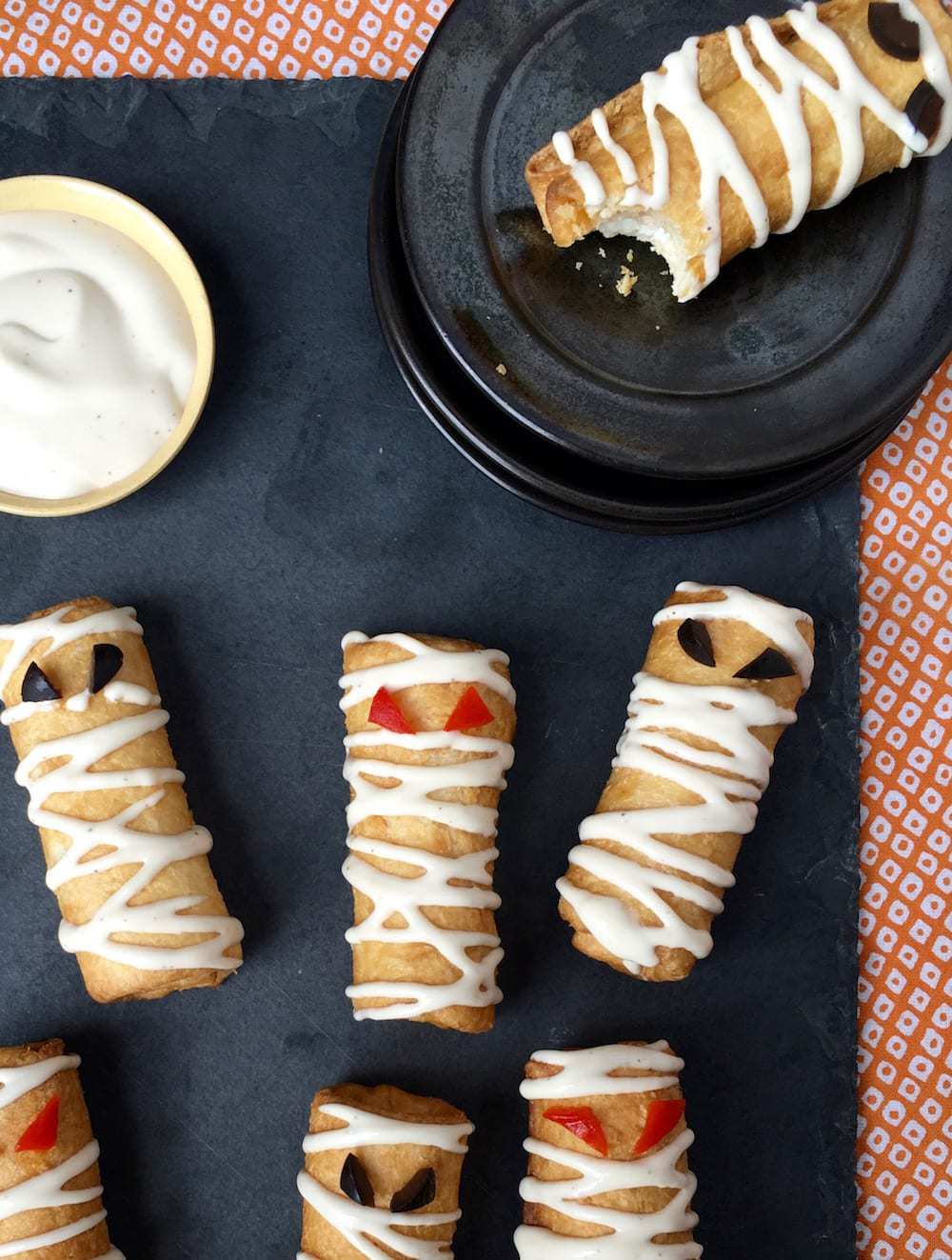 Pizza Roll Ups Mummy Snacks on slate and orange linen