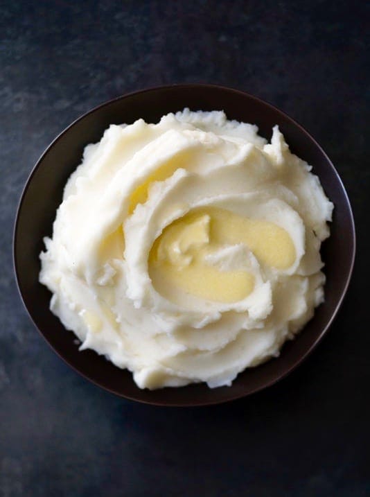 Fluffy Mashed Potatoes are as easy to make as they are delicious! TaraTeaspoon.com