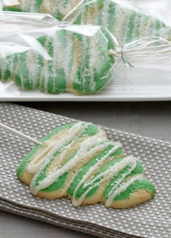  Christmas Tree Lollipop Cookies, on plate in cello and on gray napkin - close up