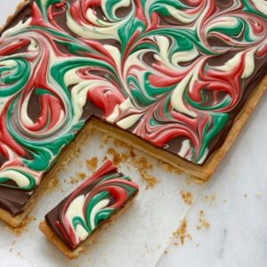 Close up of Dulce de leche bars with a missing corner on parchment