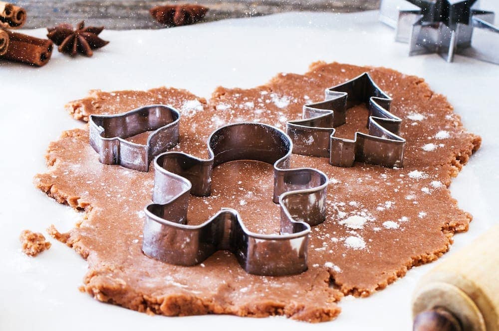 Close up of cookie cutters in the dough of The best classic gingerbread cookies