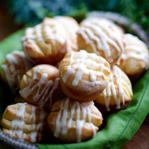 Close up of Make ahead orange rolls in basket with green napkin