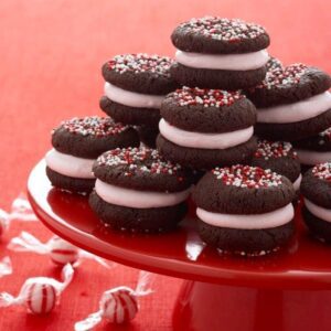 Peppermint Marshmallow Sandwich cookies with peppermint candies scattered on surface