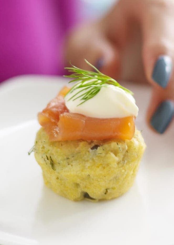 Caper Herb Corn Muffins with Smoked Salmon and creme fraiche on white plate close crop